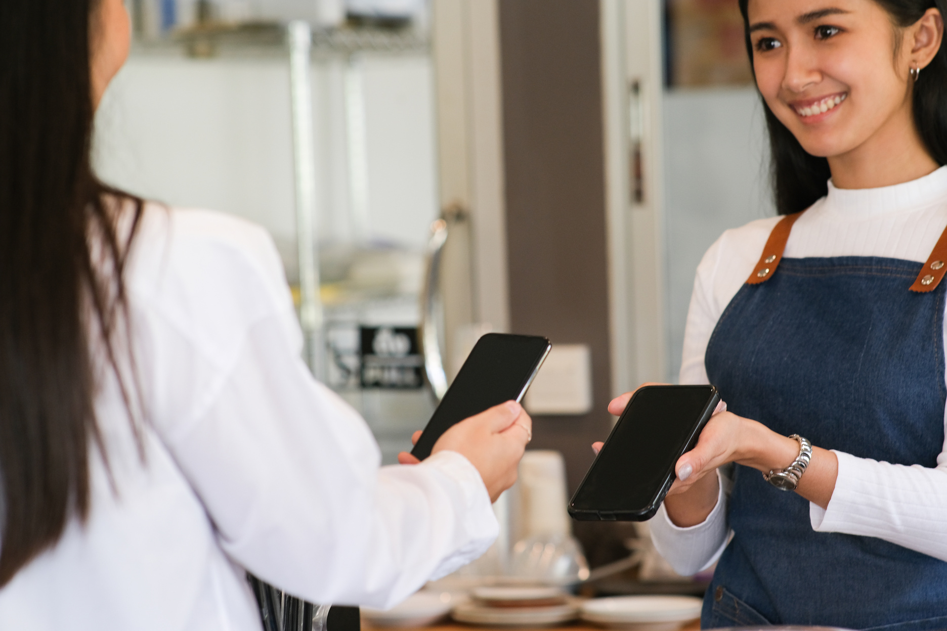 Female Customer Making Payment using NFS Technology