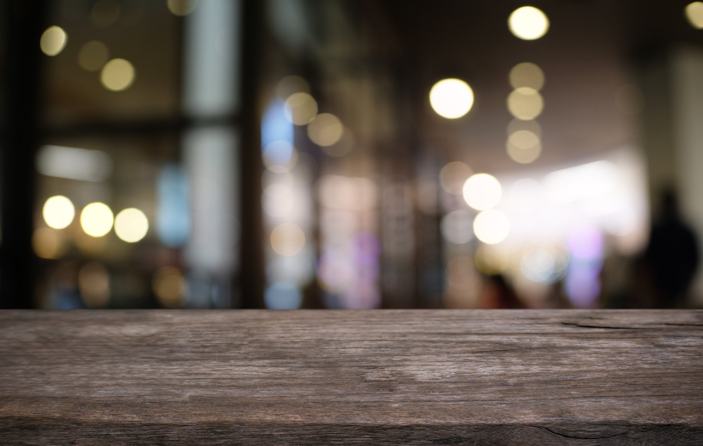 Empty dark wooden table in front of abstract blurred bokeh background of restaurant . can be used for display or montage your products.Mock up for space.